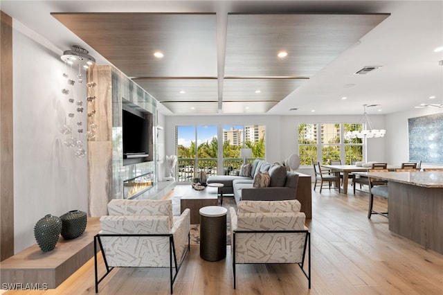 living room with light hardwood / wood-style floors and a tiled fireplace