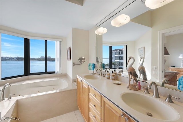 bathroom featuring vanity, a wealth of natural light, tile patterned flooring, and a water view