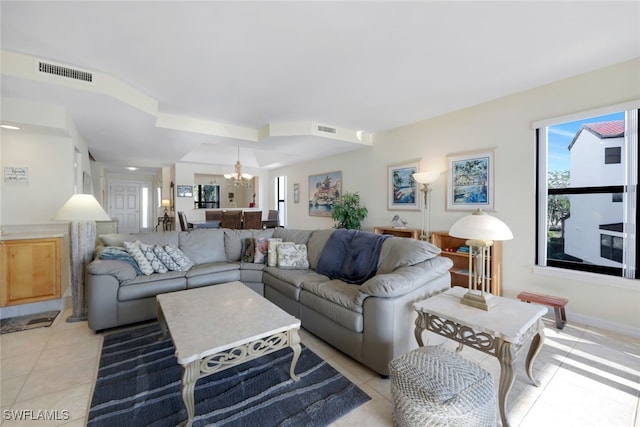 living room with light tile patterned floors and a chandelier