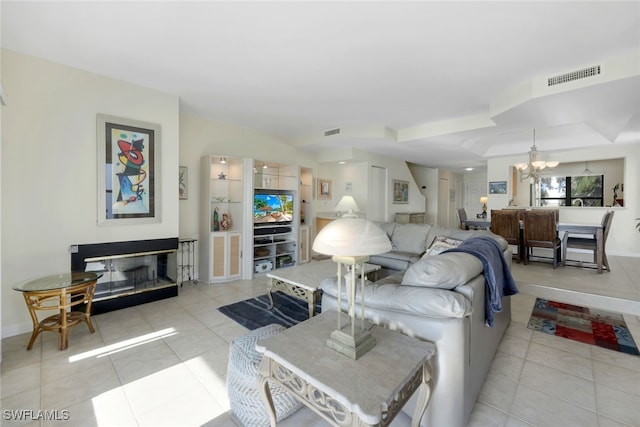 tiled living room featuring a notable chandelier