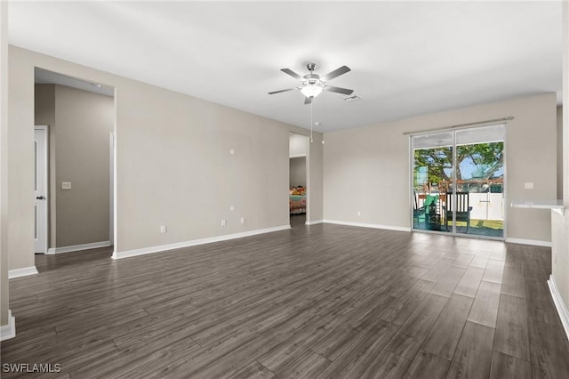 unfurnished living room with ceiling fan and dark wood-type flooring