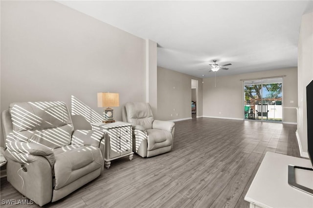 living room with ceiling fan and light wood-type flooring