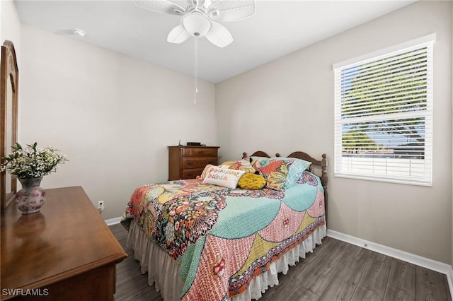 bedroom featuring multiple windows, ceiling fan, and hardwood / wood-style floors