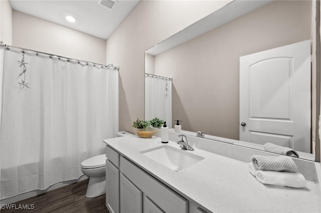 full bathroom featuring wood-type flooring, vanity, toilet, and shower / bath combo