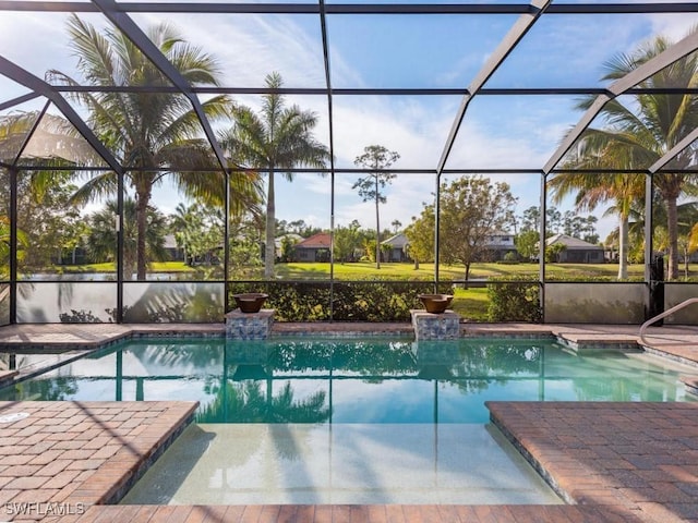 view of swimming pool with a lanai and a patio area