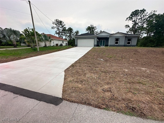 942 Sunrise Blvd, Lehigh Acres, FL 33974 - single story home featuring driveway, a garage, and stucco siding