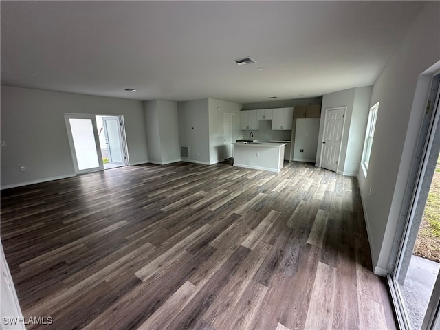 942 Sunrise Blvd, Lehigh Acres, FL 33974 - unfurnished living room with a sink and dark wood-type flooring