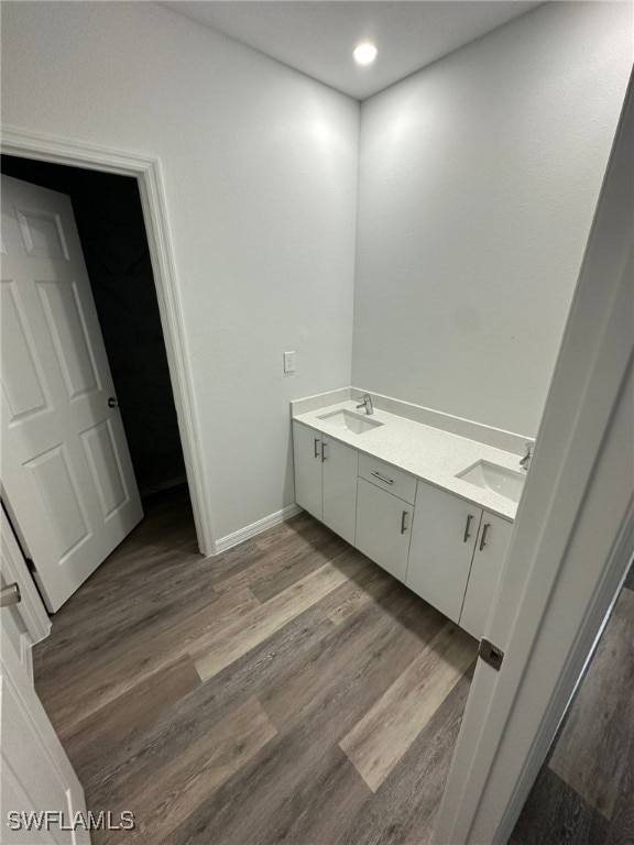 942 Sunrise Blvd, Lehigh Acres, FL 33974 - full bath featuring double vanity, wood finished floors, and recessed lighting
