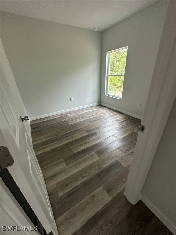 942 Sunrise Blvd, Lehigh Acres, FL 33974 - unfurnished room with wood finished floors and baseboards