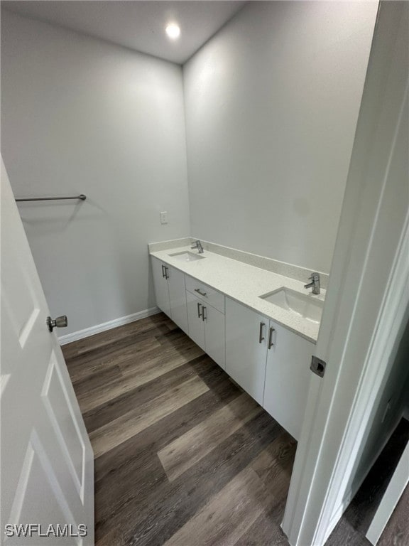 942 Sunrise Blvd, Lehigh Acres, FL 33974 - bathroom with double vanity, wood finished floors, and recessed lighting