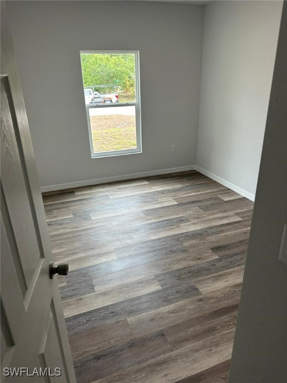 942 Sunrise Blvd, Lehigh Acres, FL 33974 - empty room featuring wood finished floors and baseboards