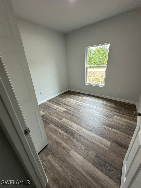 942 Sunrise Blvd, Lehigh Acres, FL 33974 - spare room featuring wood finished floors and baseboards