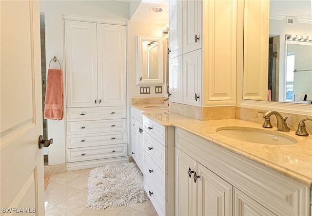 bathroom featuring vanity, tile patterned flooring, and ornamental molding