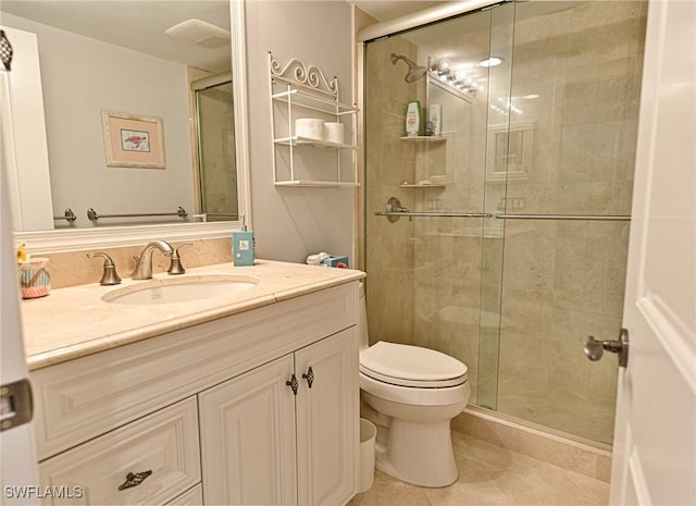 bathroom featuring walk in shower, vanity, tile patterned floors, and toilet