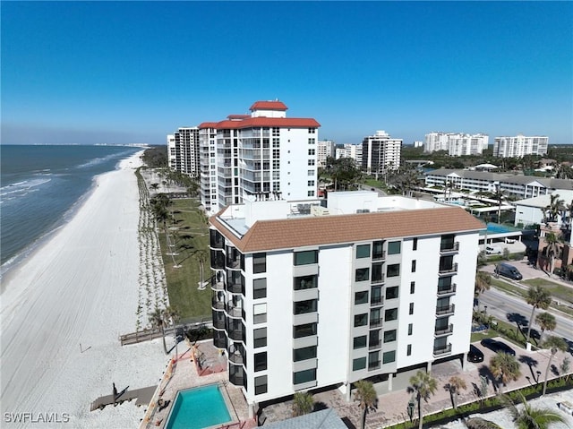 birds eye view of property with a beach view and a water view