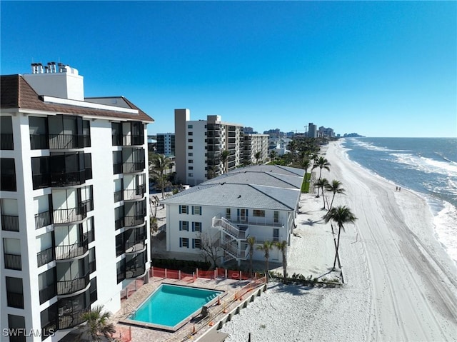 drone / aerial view with a beach view and a water view