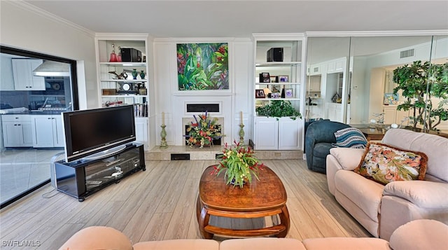 living room featuring light hardwood / wood-style floors and crown molding