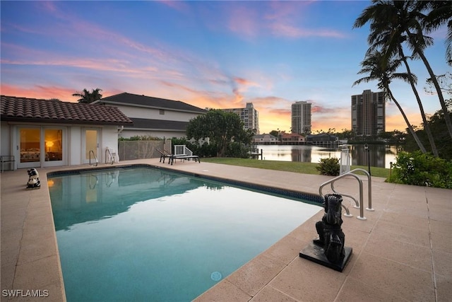 319 Pirates Bight, Naples, FL 34103 - pool at dusk with a city view, a patio, an outdoor pool, and a water view