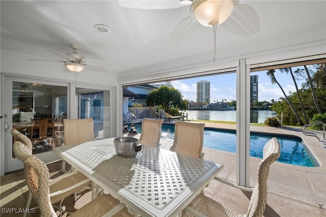 319 Pirates Bight, Naples, FL 34103 - sunroom / solarium featuring a swimming pool, ceiling fan, and a water view