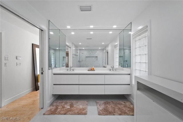 319 Pirates Bight, Naples, FL 34103 - full bath featuring a sink, visible vents, double vanity, and a shower stall