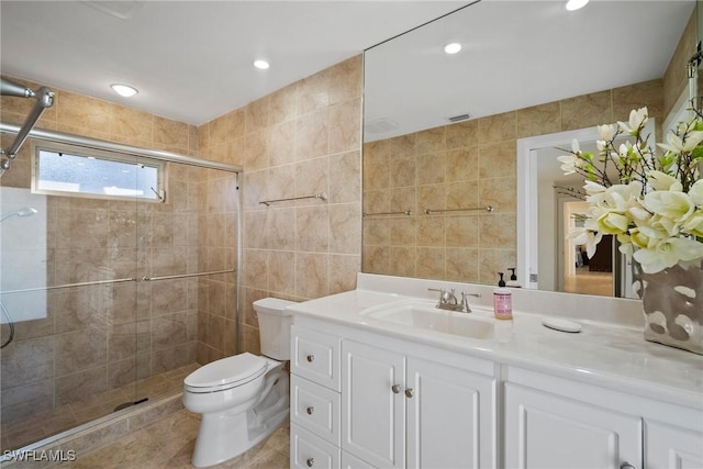 319 Pirates Bight, Naples, FL 34103 - full bathroom featuring vanity, toilet, tile walls, and a shower stall