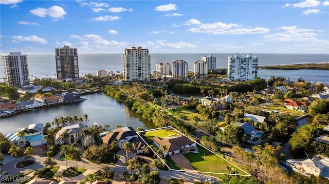 birds eye view of property featuring a water view and a view of city