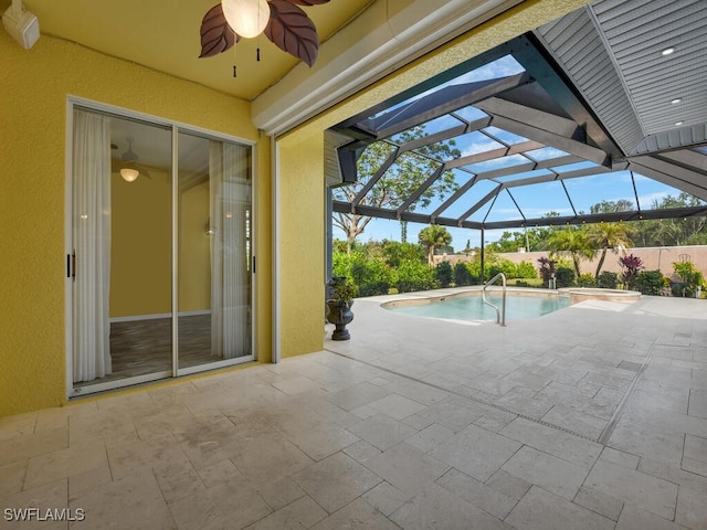 view of pool with a patio and glass enclosure