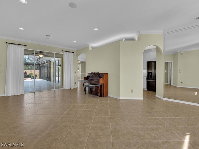 spare room featuring ornamental molding and light tile patterned flooring