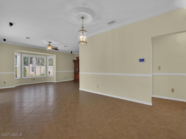 tiled empty room featuring ceiling fan and crown molding