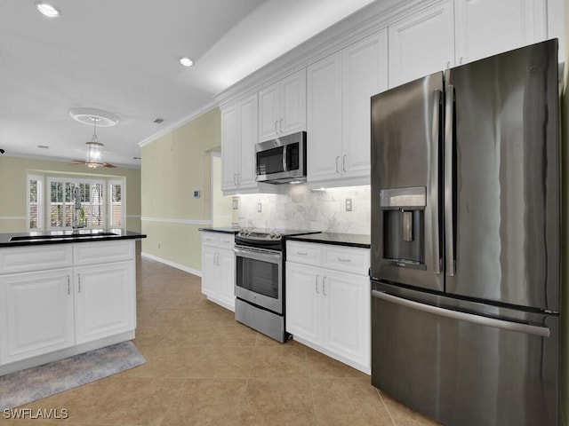 kitchen with white cabinets, light tile patterned floors, decorative backsplash, crown molding, and appliances with stainless steel finishes