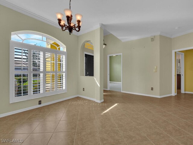 spare room with light tile patterned flooring, crown molding, and a notable chandelier