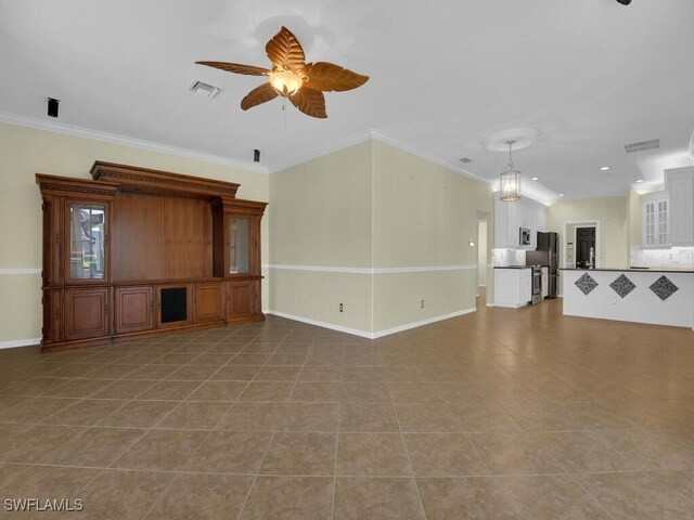 unfurnished living room with ceiling fan with notable chandelier, tile patterned flooring, and crown molding