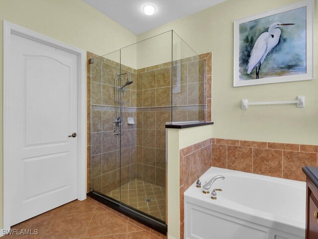 bathroom with shower with separate bathtub, vanity, and tile patterned floors