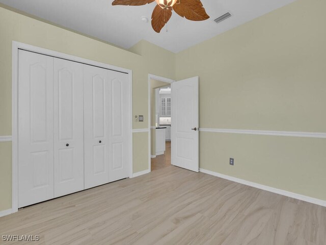 unfurnished bedroom with a closet, ceiling fan, and light hardwood / wood-style floors