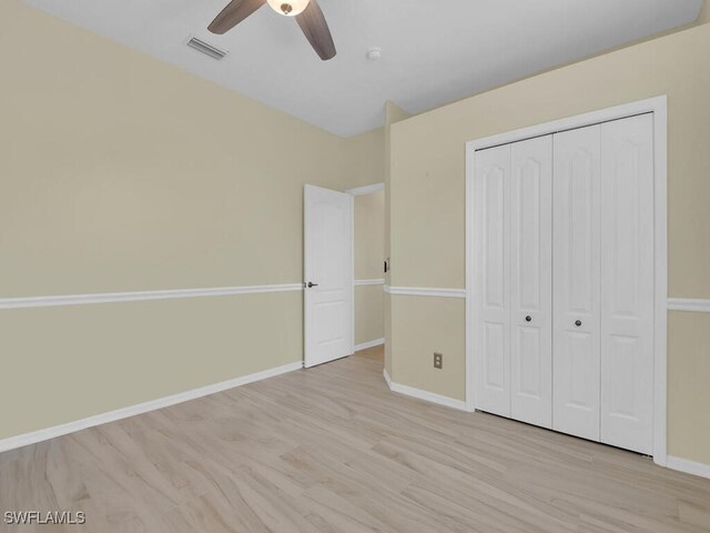 unfurnished bedroom with ceiling fan, light hardwood / wood-style floors, and a closet