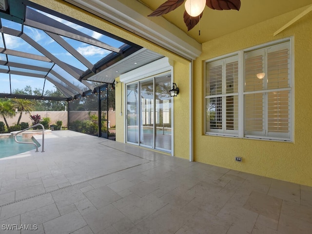 view of patio with ceiling fan, a fenced in pool, and glass enclosure