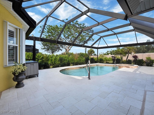 view of swimming pool featuring an in ground hot tub, a patio area, and glass enclosure