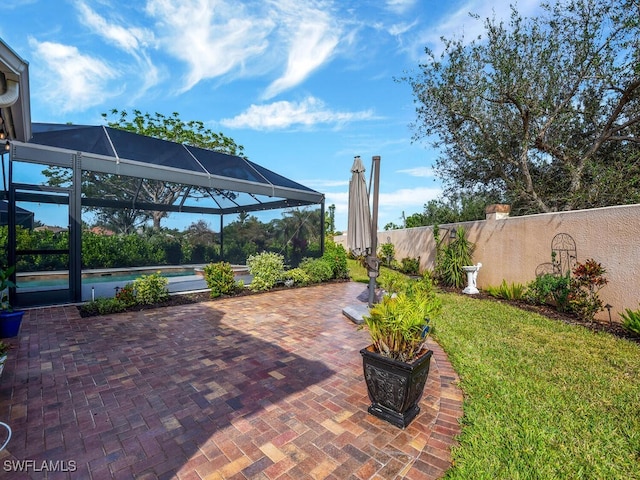 view of patio / terrace with a swimming pool and glass enclosure