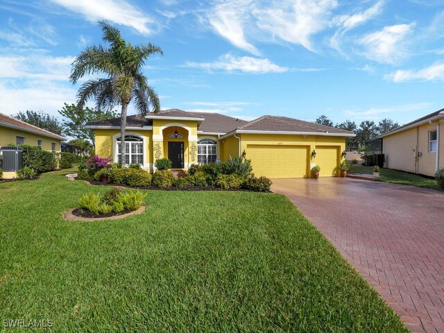 view of front facade featuring central AC unit, a front lawn, and a garage