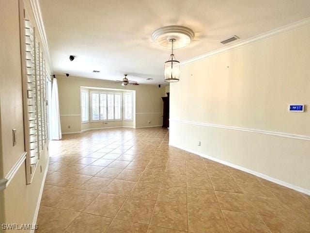 tiled spare room featuring crown molding and ceiling fan