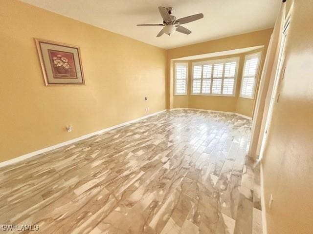 unfurnished room with wood-type flooring and ceiling fan