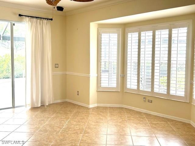 unfurnished room with ceiling fan, ornamental molding, and light tile patterned floors