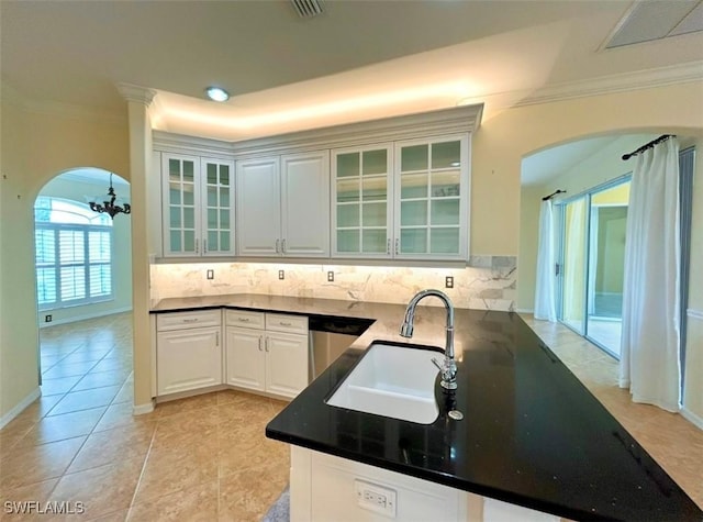 kitchen featuring white cabinetry, sink, ornamental molding, and decorative backsplash