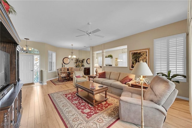 9209 Garden Pointe, Fort Myers, FL 33908 - living room with plenty of natural light, ceiling fan with notable chandelier, and light wood-type flooring