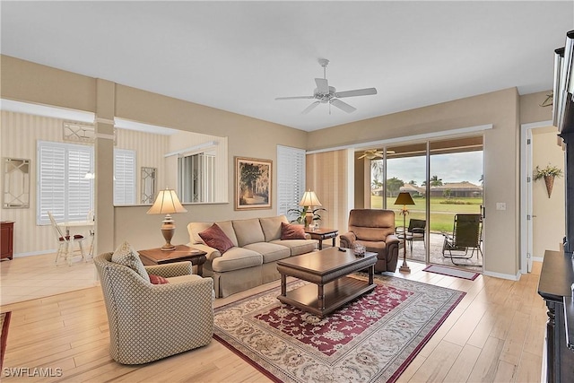 living room with ceiling fan and light wood-type flooring