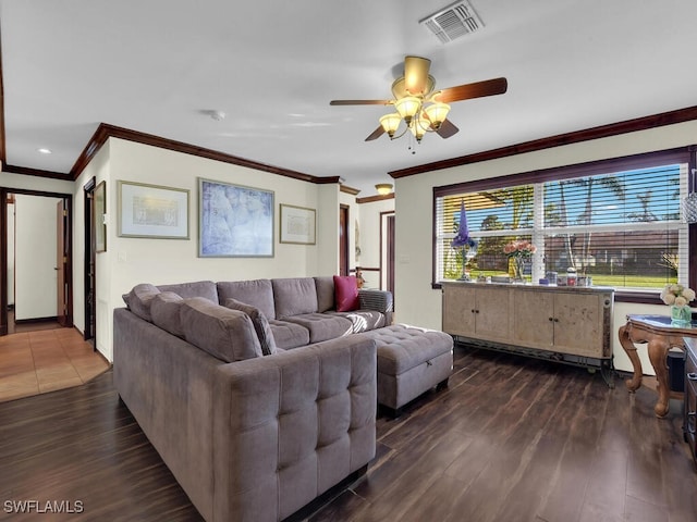 living room featuring dark hardwood / wood-style floors, ceiling fan, and crown molding