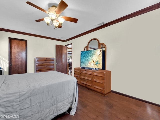 bedroom featuring ornamental molding, ceiling fan, and dark wood-type flooring