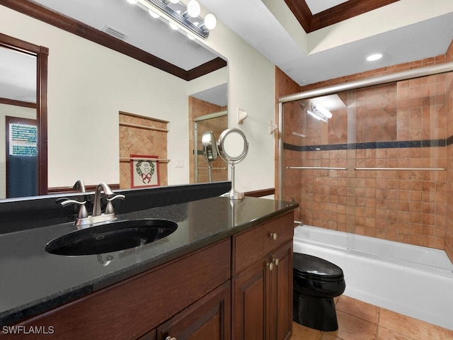 full bathroom with combined bath / shower with glass door, ornamental molding, vanity, tile patterned flooring, and toilet