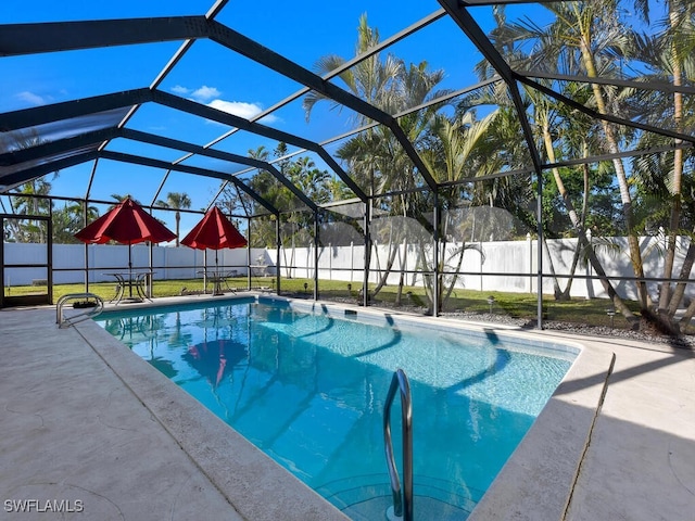 view of swimming pool with a lanai and a patio area