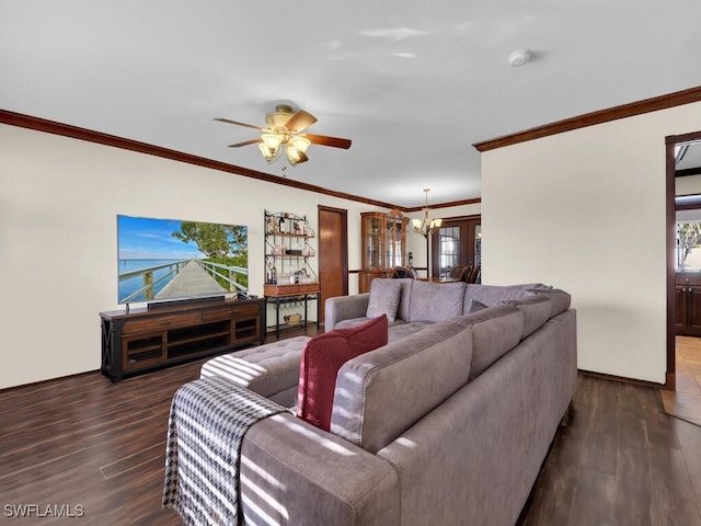 living room with ceiling fan with notable chandelier, ornamental molding, and dark wood-type flooring